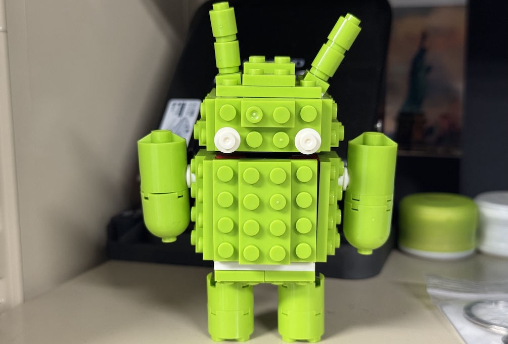 Green Lego Android droid standing healthy on a shelf